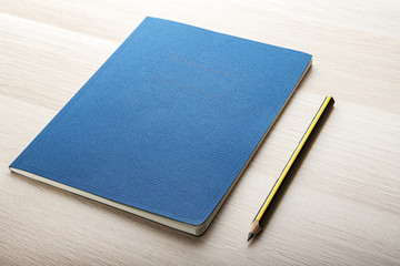 notepad on wooden desk with pencil 