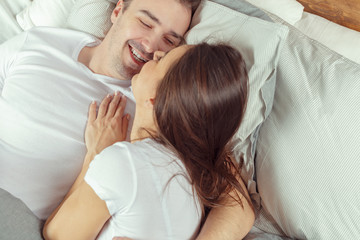 beautiful couple lying together on the bed