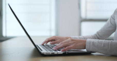 Woman working on laptop computer at home