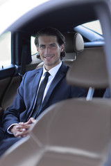 businessman sitting in a comfortable car