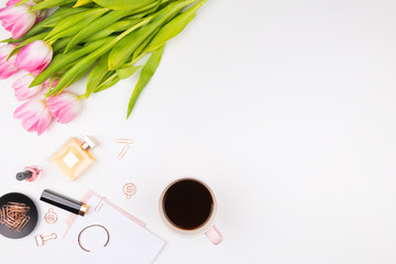 Decorative cosmetics, makeup tools, pink tulips and accessories on white background. Beauty and fashion concept. Flat lay composition, top view.