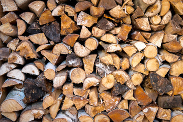 Pile of dry stacked firewood for winter