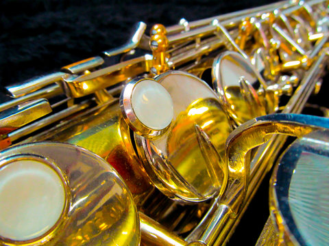 Old golden saxophone close-up.
Beautiful vintage shiny brass jazz musical instrument.