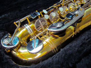 Old golden saxophone in a black fur case close-up.
Beautiful vintage shiny brass jazz musical...
