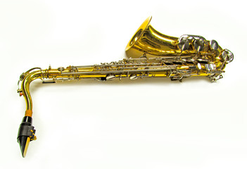 Old golden saxophone on white background.
Beautiful vintage shiny brass jazz musical instrument.