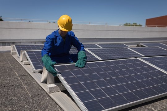 Male worker working at solar station