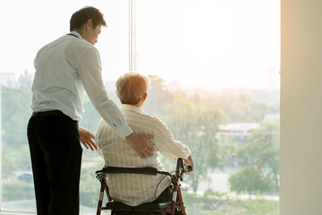 Old man on wheel chair and doctor in hospital Healthcare and Medical concept for comercial