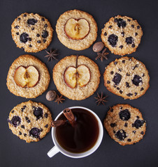 Oatmeal cookies / Oatmeal cookies with apples, dried fruits and coffee on a dark background top view