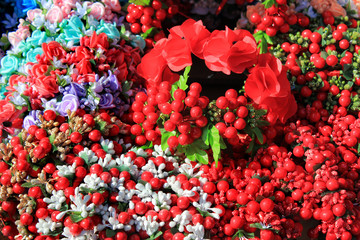 Obraz na płótnie Canvas Artificial flowers with decorative beads and bracelets