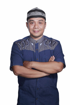 Portrait Smiling asian muslim man crossed his hand on white background
