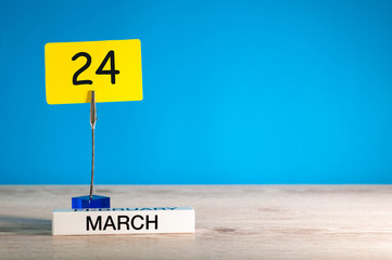 March 24th. Day 24 of march month, calendar on little tag at blue background. Spring time. Empty space for text, mockup