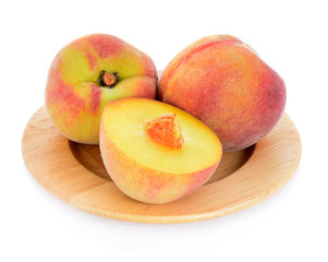Peach in wood plate isolated on a white background