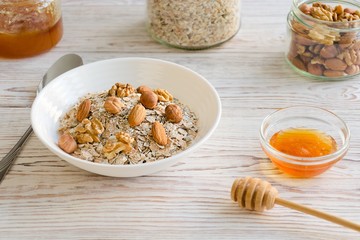 Bowl of muesli and nuts with honey.