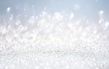 Glitter background in pastel delicate silver light blue and white tones de-focused.