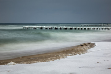 Frozen breakwaters on the popular beach in Chalupy village near Hel, Poland