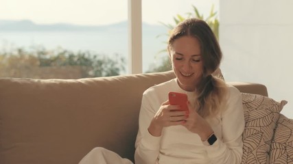 Happy woman rejoicing winnings in mobile game. Cheerful woman winning in lottery