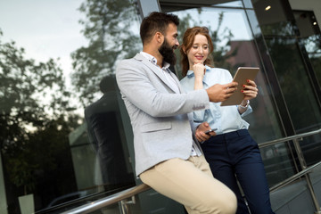 Young business couple walking outdoor near office building
