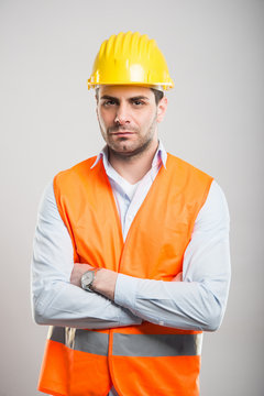 Portrait of young architect standing with arms crossed