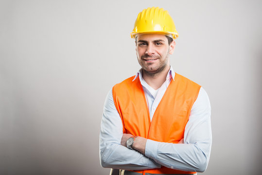Portrait of young architect standing with arms crossed