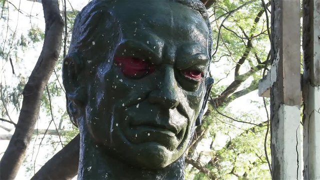 A Vandalized Statue of Agustin Pio Barrios Mangore with Red Graffitied Eyes in Bernardino Caballero Public Park, in Asuncion, Paraguay. Close Up.
