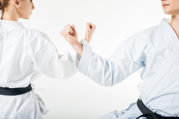Cropped image of karate fighters showing block with hands isolated on white © LIGHTFIELD STUDIOS