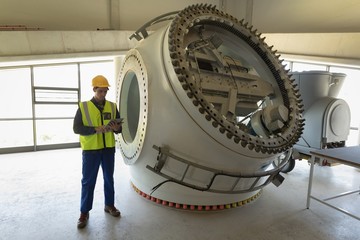 Male worker using digital tablet at solar station