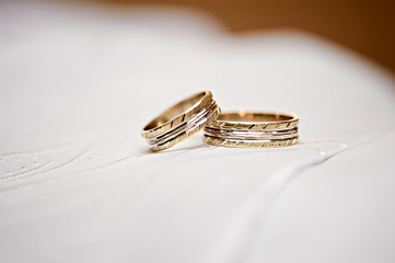 Two isolated golden wedding rings on white background