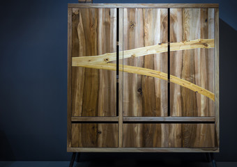 Modern wooden wardrobe made of different kinds of wood using variorus wood processing techniques