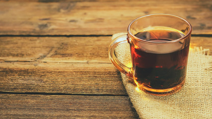 tea in a cup on a wooden background.