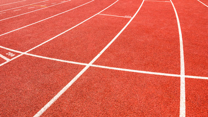 Fototapeta premium red running track on athletic stadium