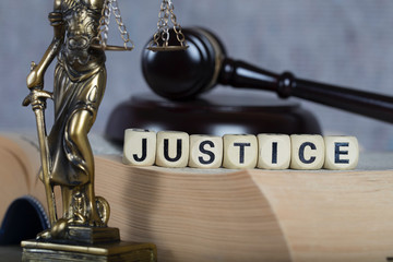 Word JUSTICE composed of wooden letters.