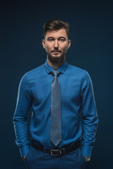 Confident man in blue shirt isolated on blue