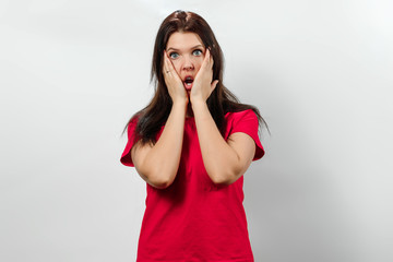 Young, beautiful girl, covers her face with her hands. Isolated on a light background. Different human emotions, feelings of facial expression, attitude, perception, body language, reaction.