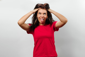 Fototapeta premium Young, beautiful girl has a disheveled hair, a bad day for hair, isolated on a light background. Different human emotions, feelings of facial expression, attitude, perception, body language, reaction.