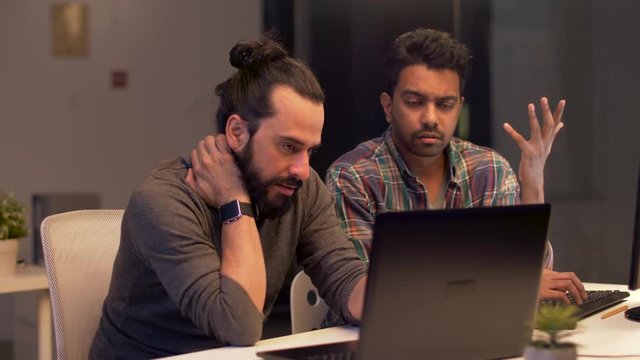 creative team with computer working late at office