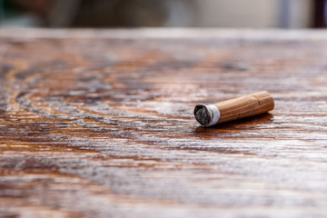 used cigarette on the wooden table. Selective and close focus