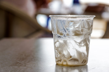 cocktail glass or empty drink is used with drops of foam on a table