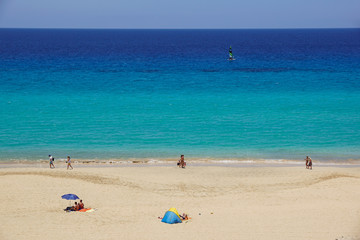 Fototapeta na wymiar Sand dune and coastal promenade along a beach in Morro Jable town, Fuerteventura, Canary Islands, Spain