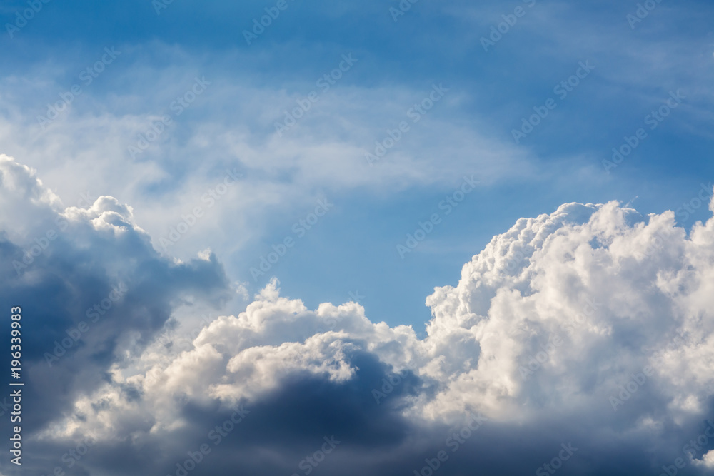 Wall mural white curly clouds in a blue sky. sky background