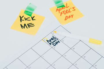 close up view of calendar with april fools day lettering isolated on grey surface, april fools day holiday concept