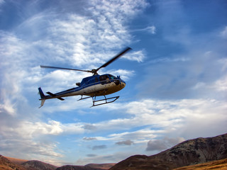 Fototapeta na wymiar Helicopter above the mountain