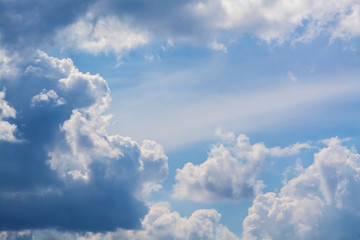 White curly clouds in a blue sky. Sky background