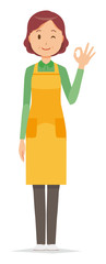 A middle-aged housewife wearing an apron is playing an okay sign