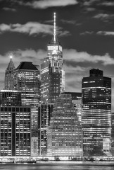 Black and white picture of Manhattan skyscrapers at night, New York City, USA.