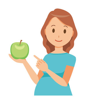 A pregnant woman wearing green clothes has a green apple