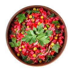 Vinaigrette salad with boiled vegetables, pickled cucumbers, sauerkraut and canned green peas in a clay bowl isolated on white. Traditional Russian snack. Vegetarian food. Top view.