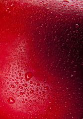 drops of water on a red apple background