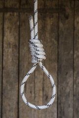 Rope knot on a teak wood background.