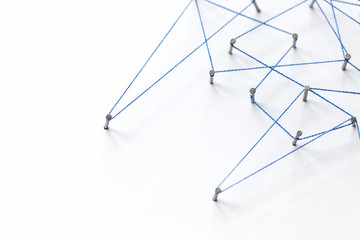 A large grid of pins connected with string. Communication, technology, network concept