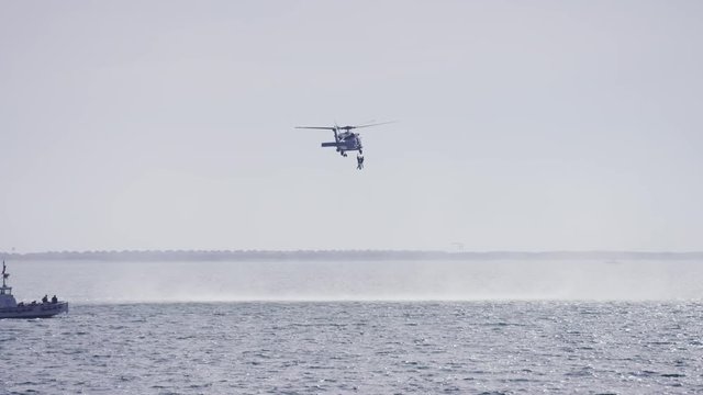 Helicopter Performing A Rescue Over Water